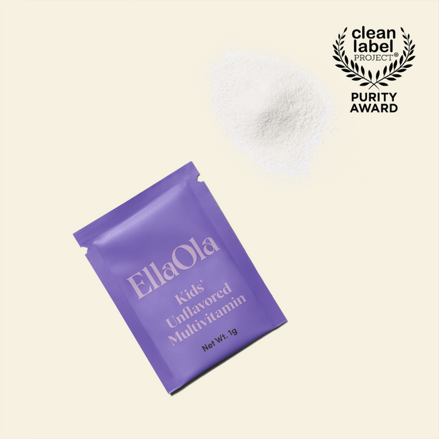 EllaOla Kids' sachet beside a small pile of fine, colorless vitamin powder